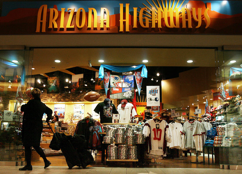 In this Jan. 29, 2008 file photo, Super Bowl merchandise is on full display in the Arizona Highways retail store at Phoenix Sky Harbor International Airport in Phoenix. Visitors spend money at NFL-funded events and buy NFL-branded memorabilia during Super Bowl week instead of frequenting local establishments, according to Philip Porter, an economics professor at the University of South Florida. (AP Photo/Ross D. Franklin, File)