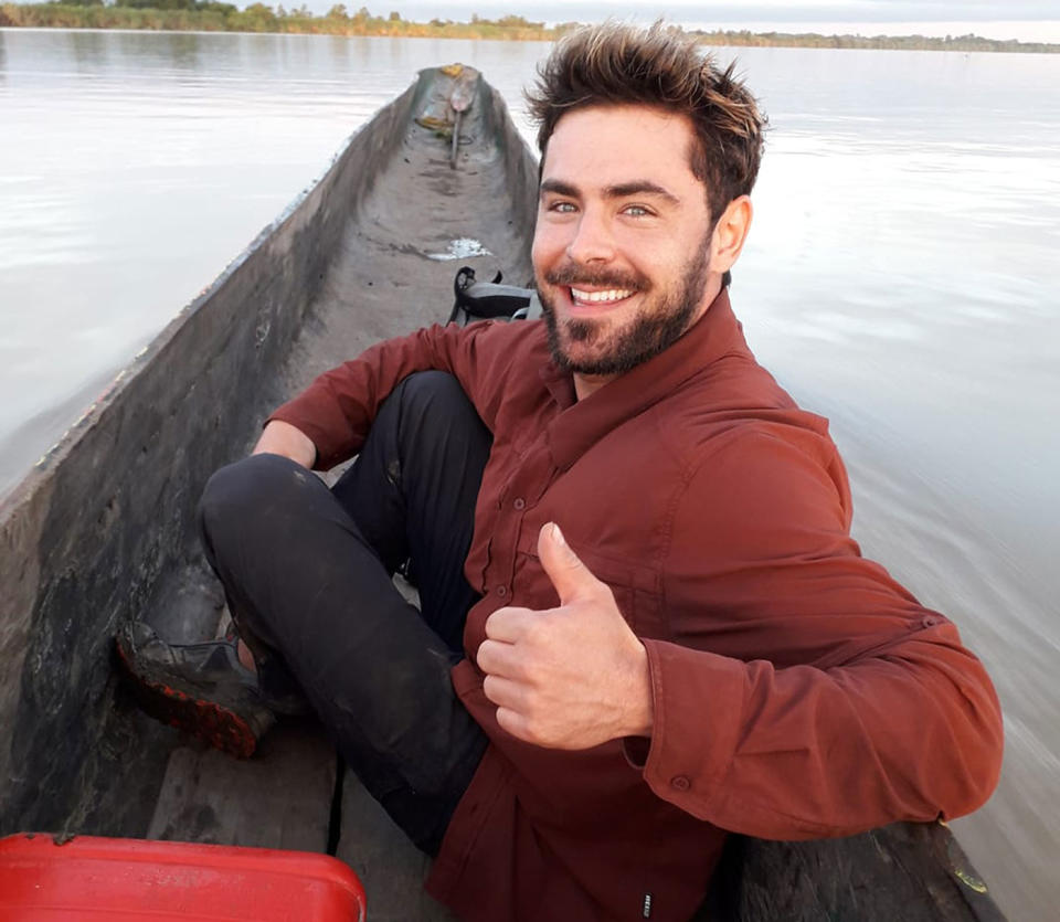 Actor Zac Efron pictured giving a thumbs up in a canoe in Papua New Guinea.