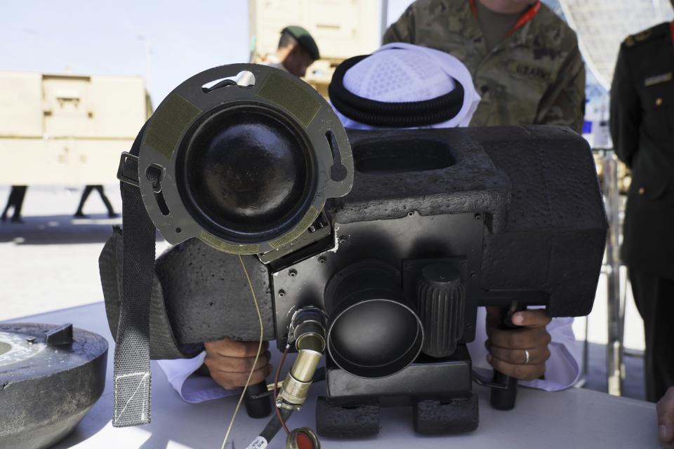 An Emirati tries a Javelin anti-tank weapon simulator at the International Defense Exhibition and Conference in Abu Dhabi, United Arab Emirates, Monday, Feb. 20, 2023. Just outside of Abu Dhabi's biennial arms fair in a large tent, Russia offered weapons for sale Monday ranging from Kalashnikov assault rifles to missile systems despite facing sanctions from the West over its war on Ukraine. (AP Photo/Jon Gambrell)