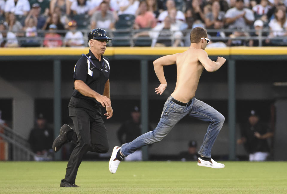 Security personnel chase a fan who ran onto the field during the fourth inning of a game between the Chicago White Sox and the Toronto Blue Jays on June 24, 2016 at U. S. Cellular Field in Chicago, Illinois. (Photo by David Banks/Getty Images)