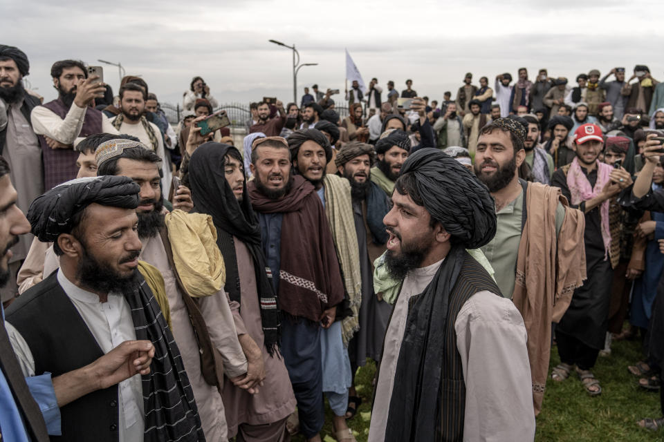 Taliban fighters celebrate one year since they seized the Afghan capital, Kabul, in Kabul, Afghanistan, Monday, Aug. 15, 2022. The Taliban marked the first-year anniversary of their takeover after the country's western-backed government fled and the Afghan military crumbled in the face of the insurgents' advance. (AP Photo/Ebrahim Noroozi)