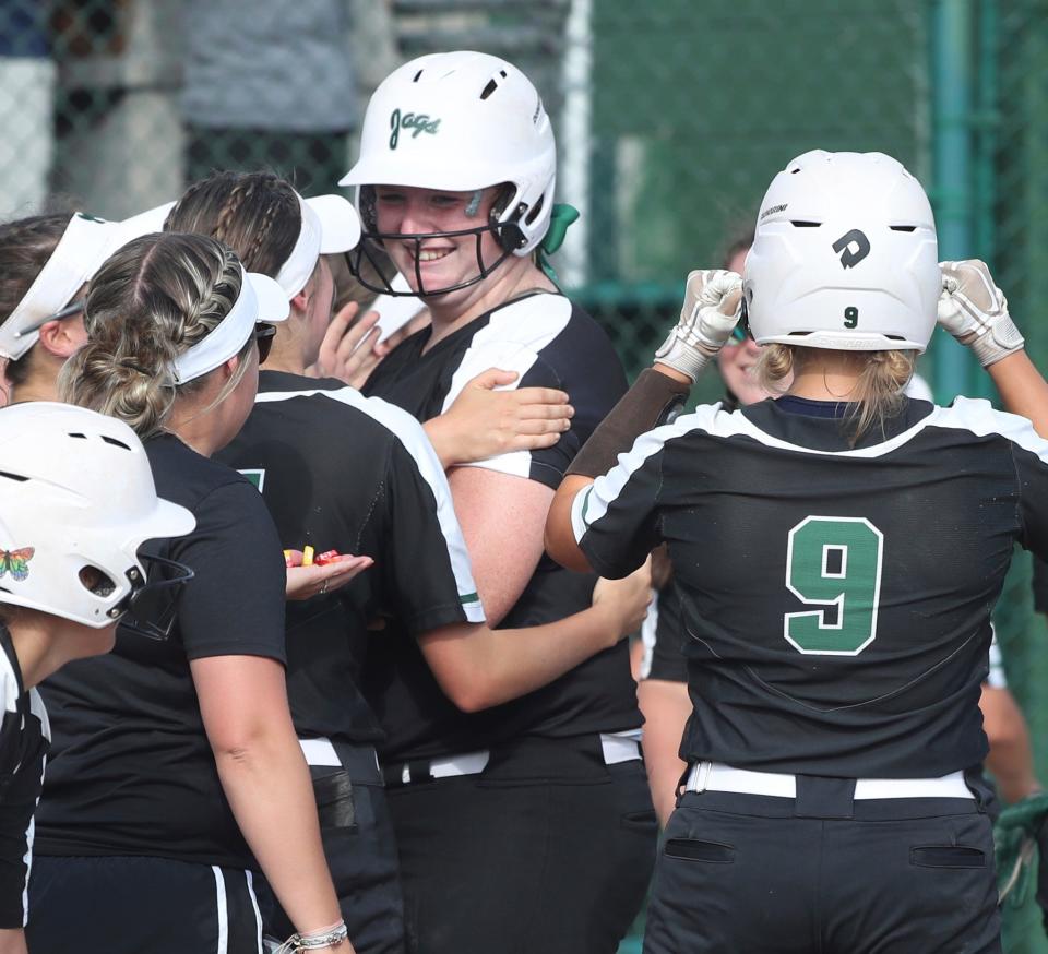 Allen Park's Morgan Sizemore is met by teammates after hitting a homer against Farmington Hills Mercy during Allen Park's 11-3 win in the Division 1 quarterfinals at Wayne State on Tuesday, June 14, 2022.