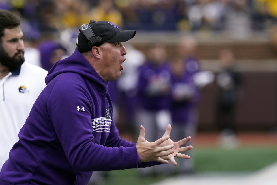 Northwestern head coach Pat Fitzgerald yells from the sideline during the first half of an NCAA college football game against Michigan, Saturday, Oct. 23, 2021, in Ann Arbor, Mich. (AP Photo/Carlos Osorio)