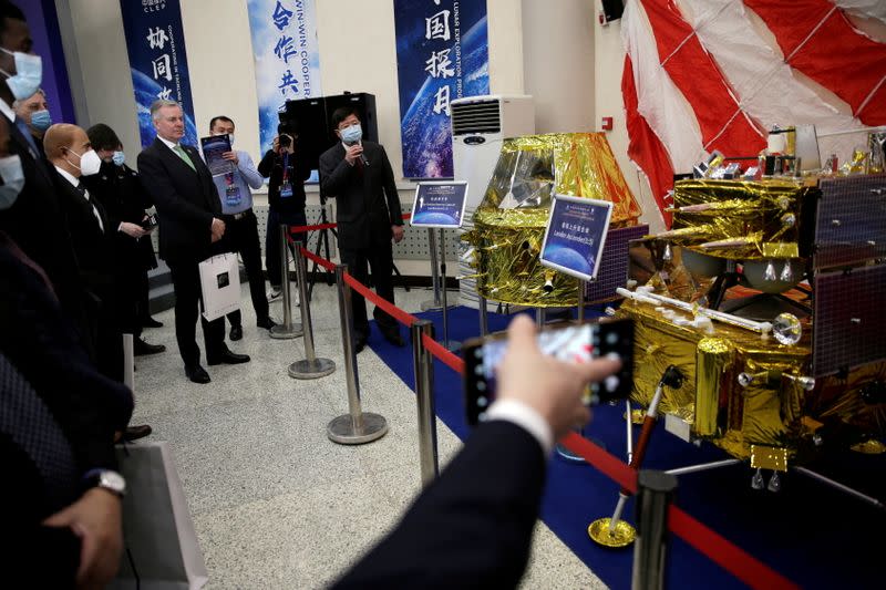 Pei Zhaoyu, spokesperson for Chang’e-5 Mission introduces models of lunar exploration spacecraft to guests, at the National Astronomical Observatories of Chinese Academy Sciences, in Beijing