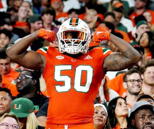 Shelton Douthett wears his full Miami Hurricanes uniform to honor his late brother, Wayne, after making a promise to wear the outfit.