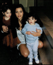 Young adult Kim held onto her little sisters Kendall and Kylie — who was still a toddler — in this precious throwback photo.