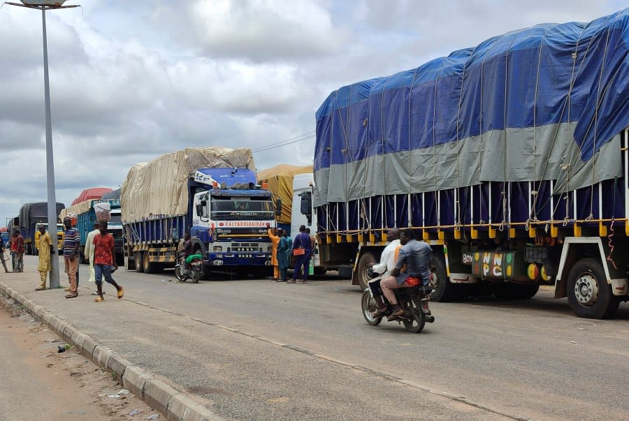 Stranded trucks with goods are seen at the border between Nigeria and Niger in Jibia, Nigeria, Monday, Aug. 7, 2023. The West Africa regional bloc’s decision to shut borders with Niger in sanctioning the country’s coup plotters is affecting businesses and locals in Nigerian towns where economic activities with Nigeriens had boomed for years. (AP Photo/Mohammed Babangida)