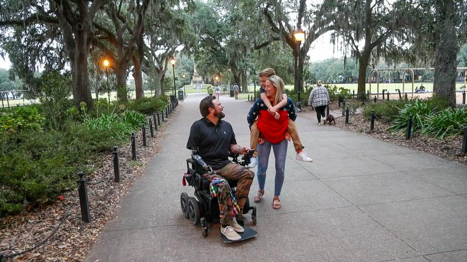 Sgt.1st Class Ryan Davis laughs with his son Knox, who gets a lift from his mom Asia while visiting Forsyth Park in Savannah, Georgia. Ryan lost both legs and his right arm due to injuries he suffered from a blast while on a mission with the U.S. Army 1st Ranger Battalion in August 2019.