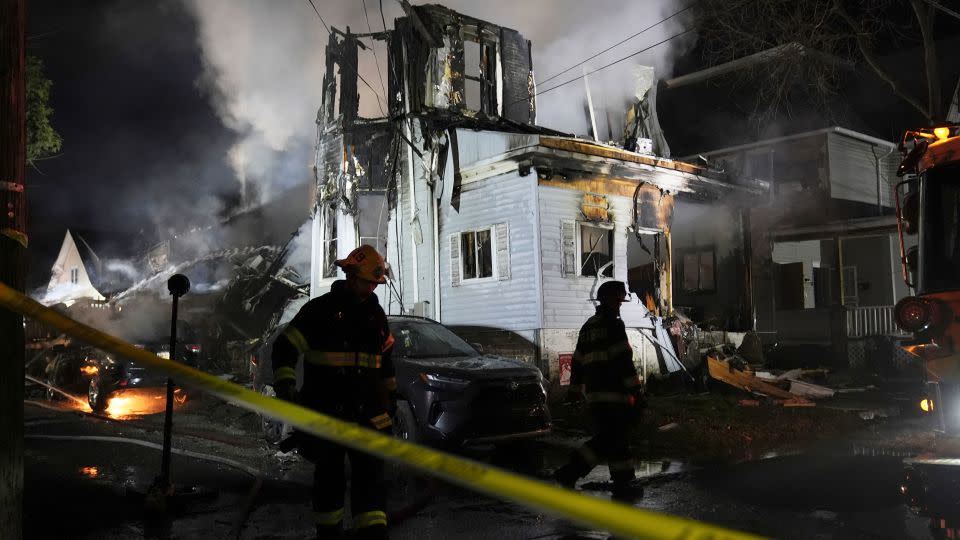 Firefighters work Wednesday at the shooting and fire scene in East Lansdowne, Pennsylvania. - Matt Rourke/AP