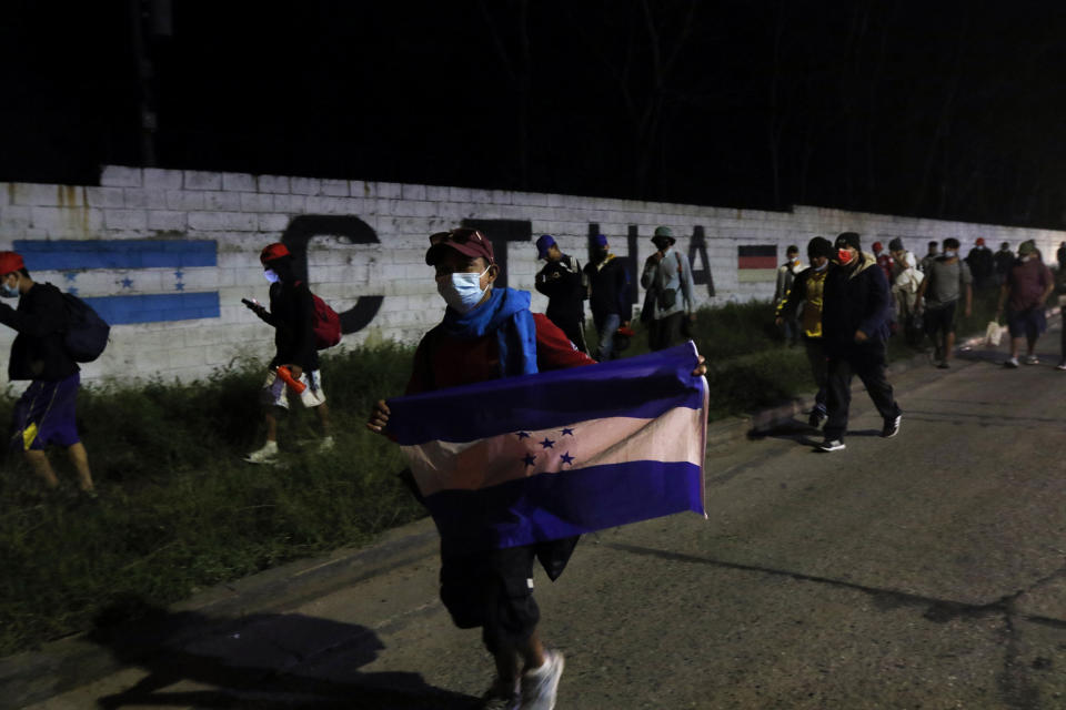 Members of a migrant caravan begin their journey in the hopes of reaching the United States, in San Pedro Sula, Honduras, Saturday, Jan. 15, 2022. (AP Photo/Delmer Martinez)