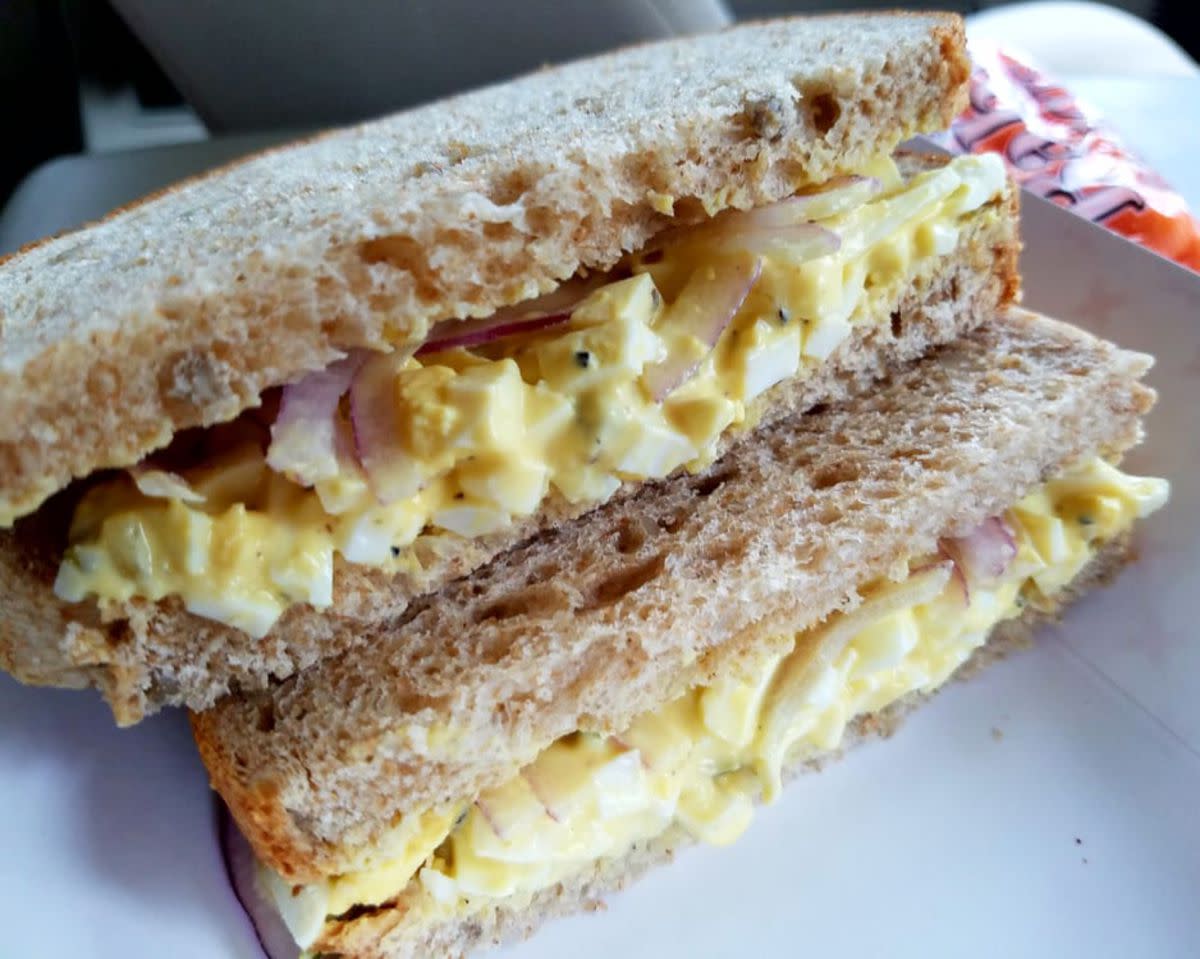 Closeup of Egg Salad Sandwich on a white plate, The Bread Basket, Cheyenne, Wyoming, with a blurred background