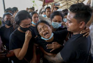 Thida Hnin cries during the funeral of her husband Thet Naing Win at Kyarnikan cemetery in Mandalay, Myanmar, Tuesday, Feb. 23, 2021. Thet Naing Win was shot and killed by Myanmar security forces during an anti-coup protest on Feb. 20. In the month since Feb. 1 coup, the mass protests occurring each day are a sharp reminder of the long and bloody struggle for democracy in a country where the military ruled directly for more than five decades. (AP Photo)