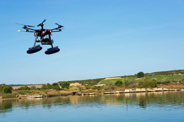 Drone or Unmanned Aerial Vehicle (UAV) used for photography / filming flying by canal de Caronte, Martigues, France