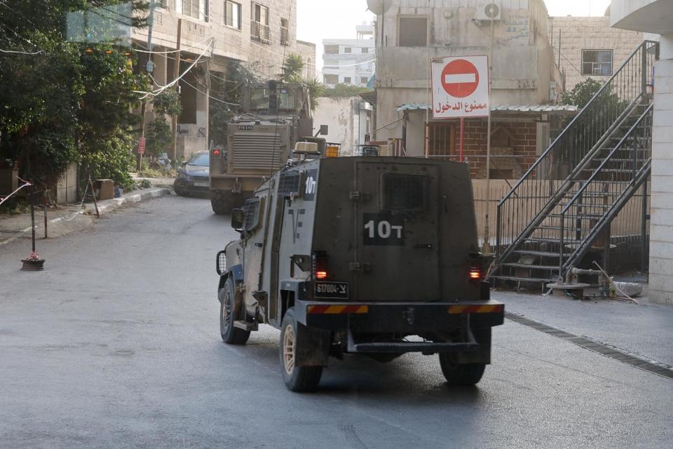 PHOTO: Israeli military vehicles move along a road in Jenin, in the Israeli-occupied West Bank, May 21, 2024.  (Raneen Sawafta/Reuters)