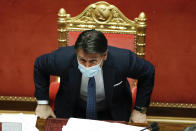 Italian Prime Minister Giuseppe Conte sits after his final address at the Senate prior to a confidence vote, in Rome, Tuesday, Jan. 19, 2021. Italian Premier Giuseppe Conte fights for his political life with an address aimed at shoring up support for his government, which has come under fire from former Premier Matteo Renzi's tiny but key Italia Viva (Italy Alive) party over plans to relaunch the pandemic-ravaged economy. (Yara Nardi/pool photo via AP)