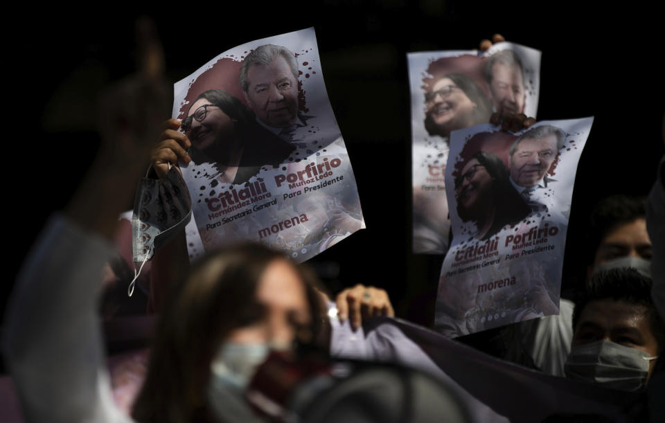 Supporters of Porfirio Munoz Ledo hold up posters of him outside Morena party headquarters, amid elections to select the party's leader in Mexico City, Monday, Oct. 12, 2020. The ruling party is making its third try at electing a party leader. (AP Photo/Fernando Llano)