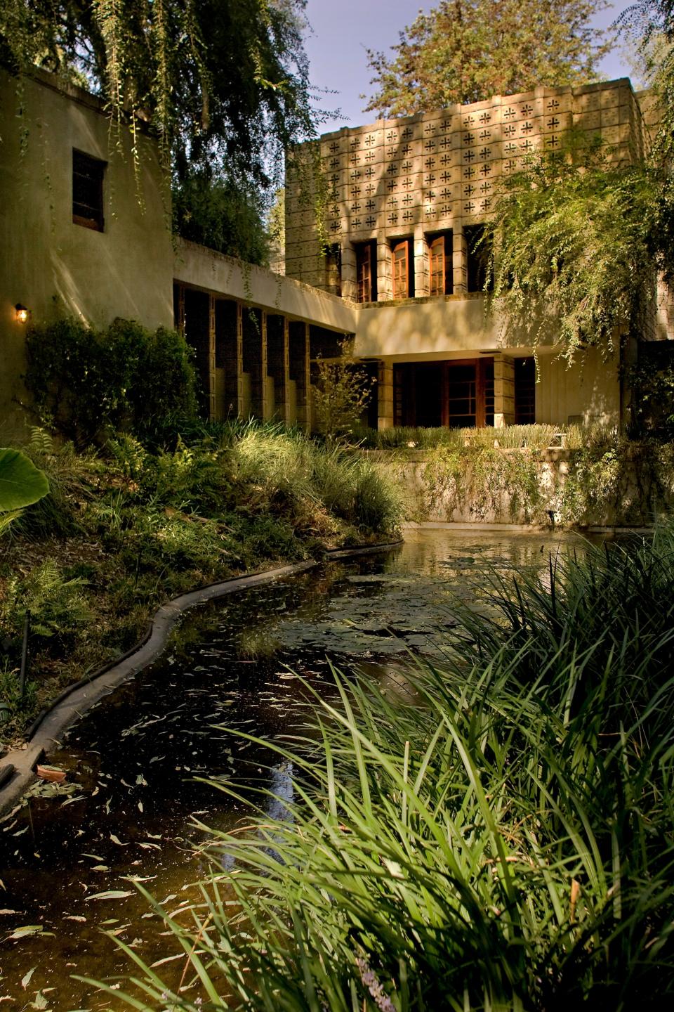 Eucalyptus trees and tall grasses on the property contribute to the structure’s overgrown, hidden temple atmosphere.