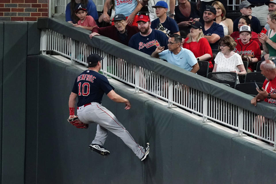 Boston Red Sox right fielder Hunter Renfroe runs against the wall after catching a line dive from Atlanta Braves' Guillermo Heredia during the fifth inning of a baseball game Wednesday, June 16, 2021, in Atlanta. (AP Photo/John Bazemore)