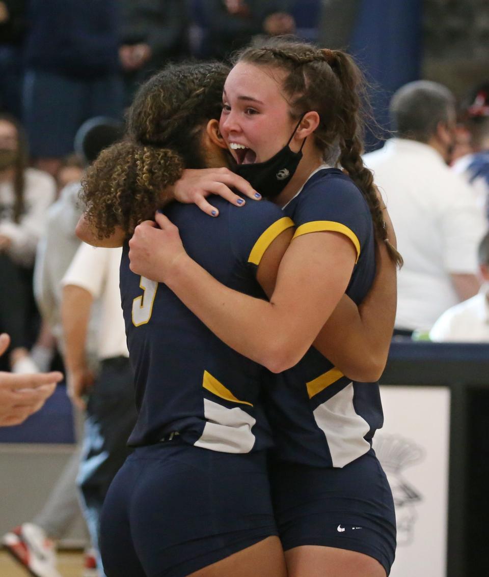 Victor's Emma Werkmeister, right, hugs teammate Alex McKenzie (3), left, as they celebrate their win over Penfield in their Section V Class AA championship finals match up Saturday, Nov. 6, 2021 at Gates Chili High School.  Victor won the close contest in five sets; 18-25, 25-23, 25-20, 20-25 and 27-25. 