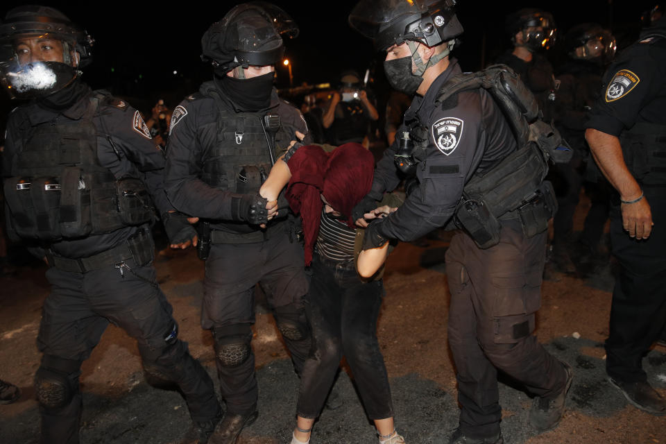 Israeli police officers detain a Palestinian demonstrator during a protest against the planned evictions of Palestinian families in the Sheikh Jarrah neighborhood of east Jerusalem, Saturday, May 8, 2021. (AP Photo/Oded Balilty)