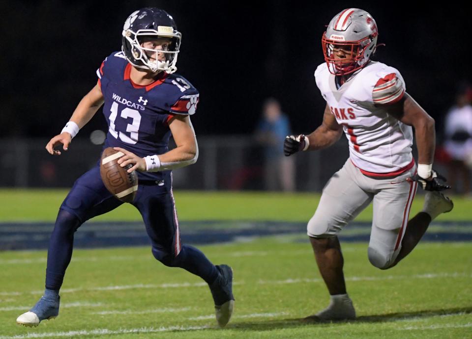 Trinity's Walker McClinton (13) is pursued by Saks’ Dorrien Walker (1) during their game on the Trinity campus in Montgomery, Ala., on Friday November 4, 2022. 