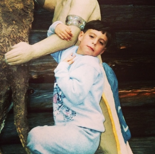 Young boy in a sweatshirt striking a pose