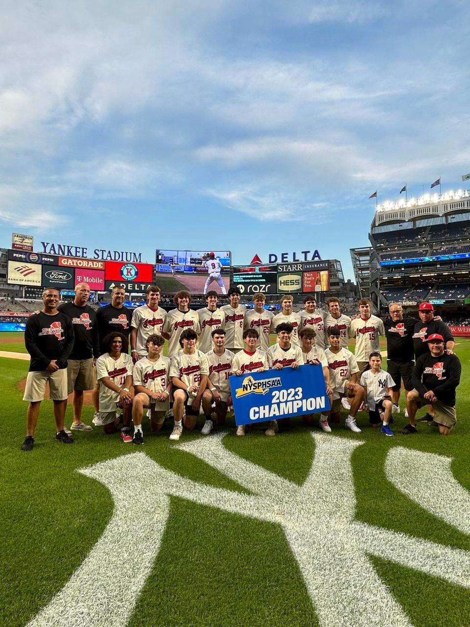 The Roy C. Ketcham baseball team poses behind home plate at Yankee Stadium on Sept. 7, 2023. After winning a high school state championship in June, the team was honored by the New York Yankees.