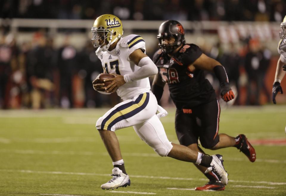 Utah defensive tackle LT Tuipulotu pursues UCLA quarterback Brett Hundley as he carries the ball