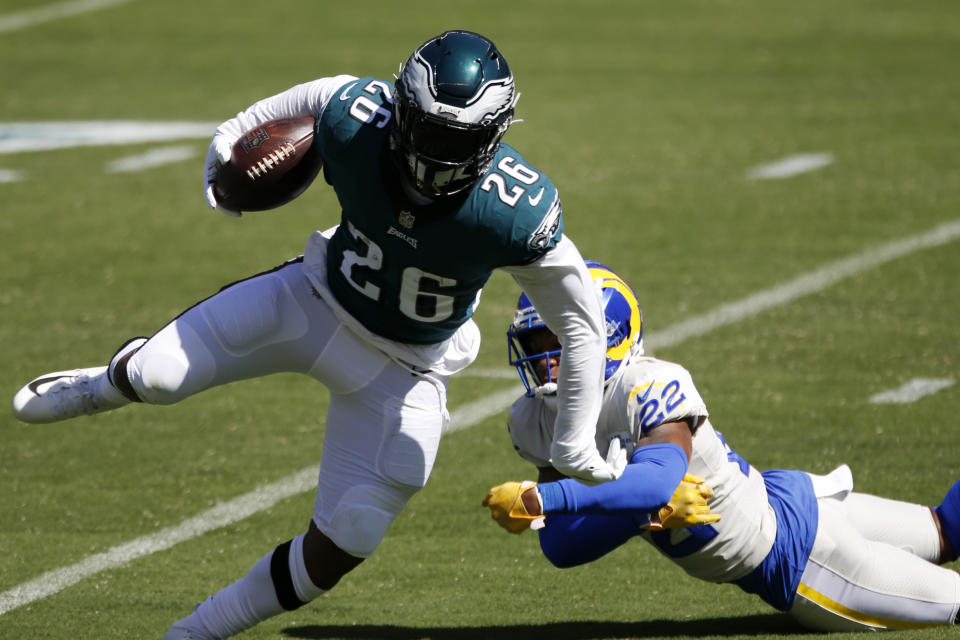 Philadelphia Eagles' Miles Sanders (26) runs past Los Angeles Rams' Troy Hill (22) during the first half of an NFL football game, Sunday, Sept. 20, 2020, in Philadelphia. (AP Photo/Laurence Kesterson)