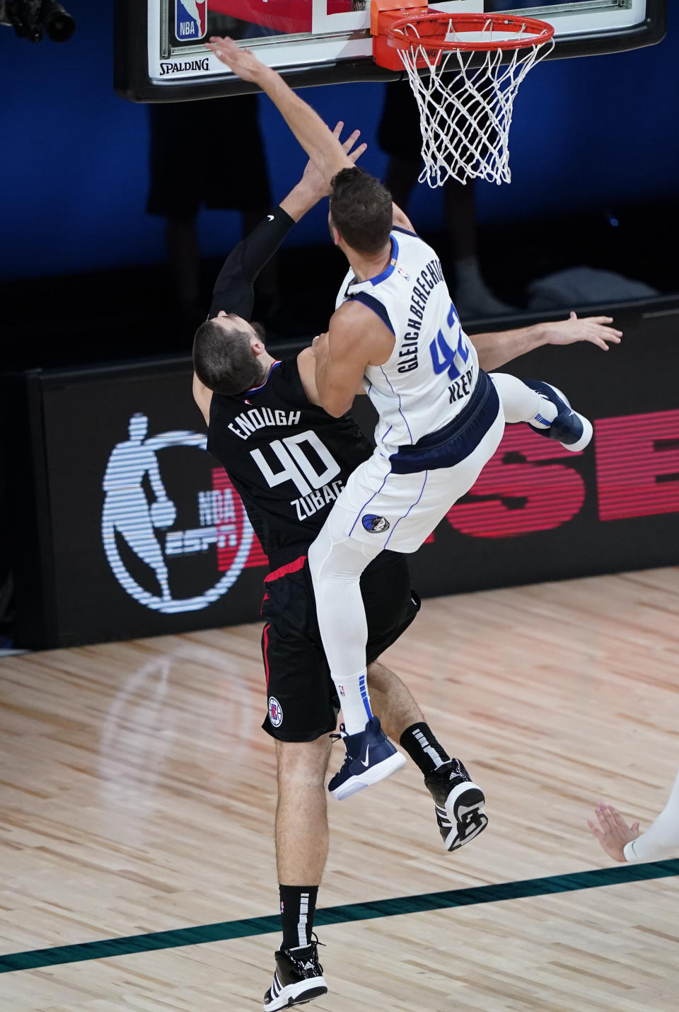 Dallas Mavericks' Maxi Kleber (42) fouls Los Angeles Clippers' Ivica Zubac (40) during the second half of an NBA first round playoff game Sunday, Aug. 30, 2020, in Lake Buena Vista, Fla. (AP Photo/Ashley Landis)