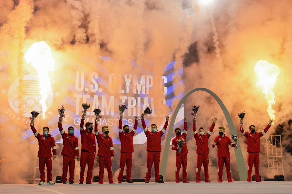 Members of the US Men's Olympic Gymnastic Team and alternates stand on stage after the conclusion of the men's U.S. Olympic Gymnastics Trials Saturday, June 26, 2021, in St. Louis. (AP Photo/Jeff Roberson)