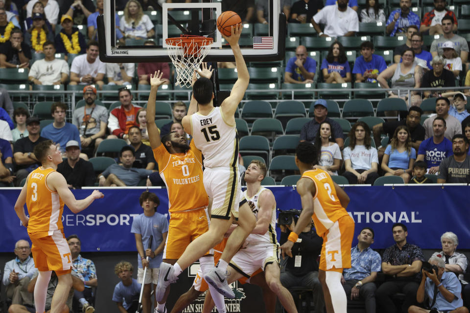 Purdue center Zach Edey (15) makes a layup against Tennessee during the second half of an NCAA college basketball game, Tuesday, Nov. 21, 2023, in Honolulu. (AP Photo/Marco Garcia)