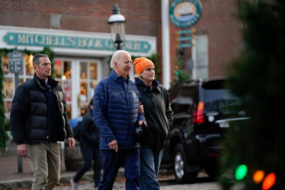 President Joe Biden walks with his granddaughter Maisy Biden as he visits local shops with family in Nantucket (AP)