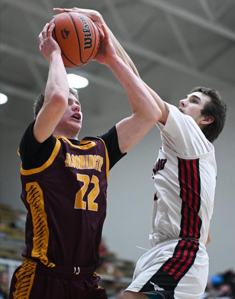 Edgewood’s Jacob Boggs blocks a shot from Bloomington North’s Luke Lindeman (22) during their game at Edgewood on Thursday, Feb. 1, 2024.