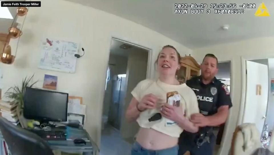 Hyde Park police Officer Joshua Kemlage with Jamie Feith a moment before police realize she had a knife during their response to a domestic violence call at her home April 29, 2022. Kemlage shot her to death moments later. This is a screen grab from body-worn camera video of state Trooper Christopher Miller that was released by the New York State Attorney General's Office. An investigation into the shooting is ongoing by the AG's Office of Special Investigation.
