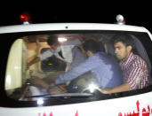 <p>Afghan men sit in an ambulance after they were rescued from the site of an attack at American University of Afghanistan in Kabul on Aug. 24, 2016. (REUTERS/Mohammad Ismail) </p>