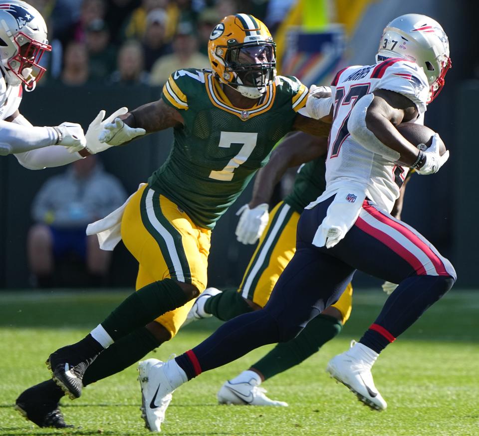 Green Bay Packers linebacker Quay Walker (7) tackles New England Patriots running back Damien Harris (37) during the first quarter of their game Sunday, October 2, 2022 at Lambeau Field in Green Bay, Wis.