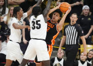 Oregon State forward Thomas Ndong, front right, is trapped with the ball by Colorado forwards Cody Williams, left, and Assane Diop (35) in the second half of an NCAA college basketball game Saturday, Jan. 20, 2024, in Boulder, Colo. (AP Photo/David Zalubowski)