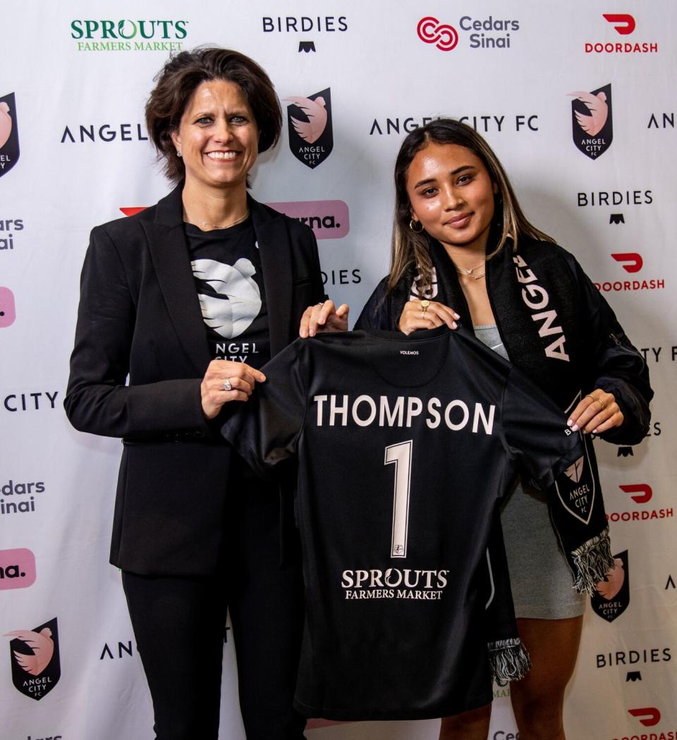Alyssa Thompson, right, stands with Angel City President Julie Uhrman with an Angel City jersey.