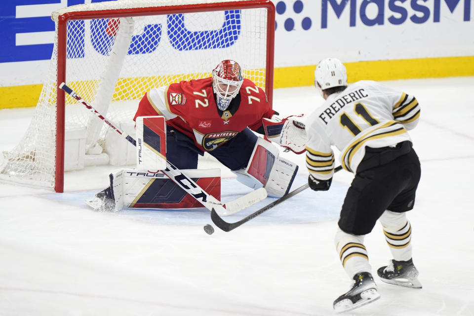 Boston Bruins center Trent Frederic (11) attempts a shot at Florida Panthers goaltender Sergei Bobrovsky (72) during the second period of Game 5 of the second-round series of the Stanley Cup Playoffs, Tuesday, May 14, 2024, in Sunrise, Fla. (AP Photo/Wilfredo Lee)