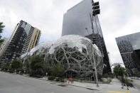 A man walks near the Amazon Spheres, Thursday, April 30, 2020, in downtown Seattle. Amazon.com is expected to announce earnings for the first quarter of 2020 at the close of markets Thursday, a report that is expected to be closely watched due to the effects of the coronavirus outbreak on the company. (AP Photo/Ted S. Warren)
