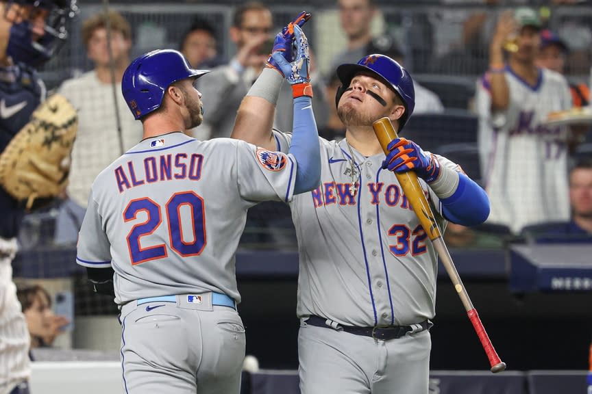 New York Mets first baseman Pete Alonso (20) celebrates his solo home run with designated hitter Daniel Vogelbach (32) during the sixth inning against the New York Yankees at Yankee Stadium.