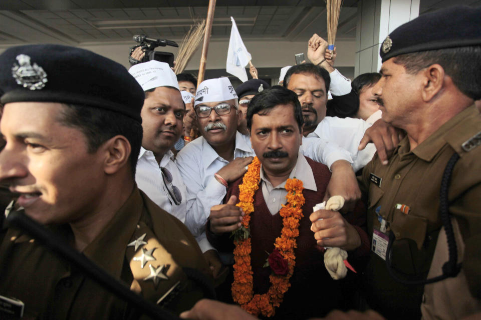 Anti-graft activist and leader of Aam Aadmi Party, or Common Man Party, Arvind Kejriwal is surrounded by supporters after his arrival at the airport as he begins his four-day visit of Gujarat state ahead of the country’s national elections, in Ahmadabad, India, Wednesday, March 5, 2014. India said Wednesday it will begin national elections on April 7, kicking off a month-long contest in the largest democracy in the world. More than 810 million people are eligible to vote this year, an increase of 100 million from five years ago, according to the Election Commission. (AP Photo/Ajit Solanki)