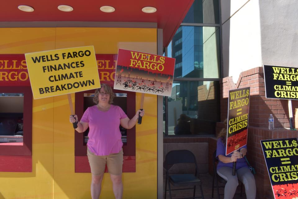 Kathy Mohr-Almeida protests Wells Fargo's financing of fossil fuels emissions outside of a branch in downtown Tempe.