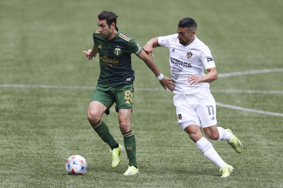 Portland Timbers midfielder Diego Valeri (8) dribbles ahead of LA Galaxy midfielder Sebastian Lletget (17) during the first half of an MLS soccer match, Saturday, May 22, 2021, in Portland, Ore. (AP Photo/Amanda Loman)