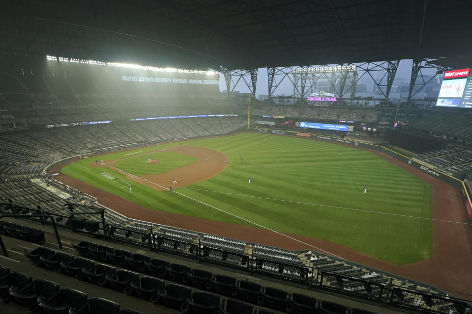 FILE - In this Sept. 14, 2020, file photo, smoke from wildfires in Oregon and California create hazy conditions at T-Mobile Park in Seattle during a baseball game between the Seattle Mariners and the Oakland Athletics. Wildfires churning out dense plumes of smoke as they scorch huge swaths of the U.S. West Coast have exposed millions of people to hazardous pollution levels, causing emergency room visits to spike and potentially thousands of deaths among the elderly and infirm, according to an Associated Press analysis of pollution data and interviews with physicians, health authorities and researchers. (AP Photo/Ted S. Warren, File)