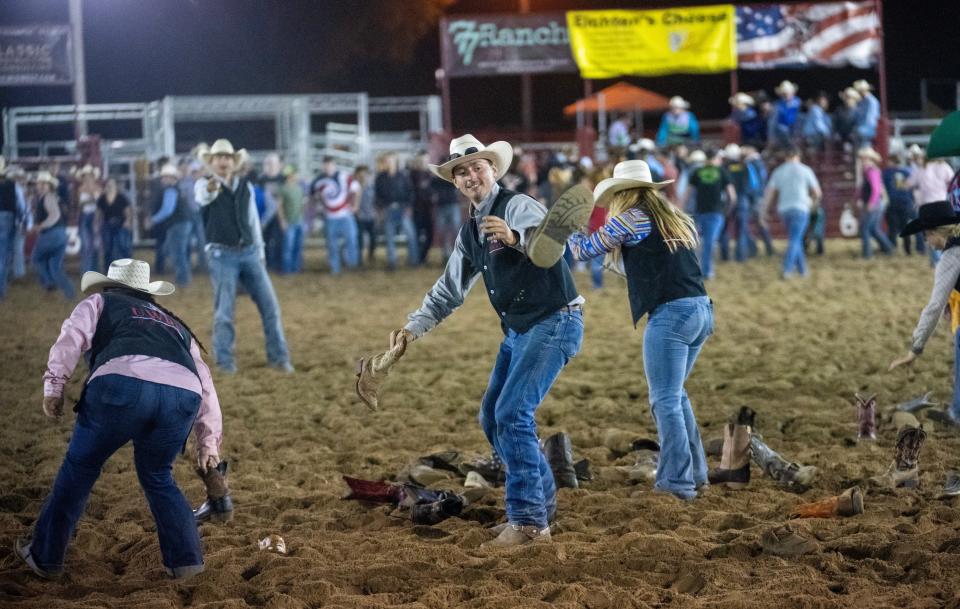 Tyler Gardner helps his UW-River Falls Rodeo teammates toss spectators' boots during a game at the Falcon Frontier Rodeo.