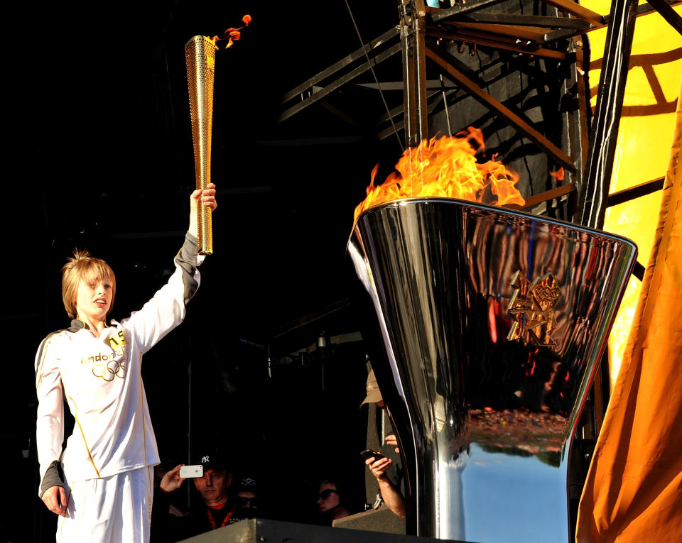 Aaron Bell Olympic Torch Bearer selected through Coca-Cola's Future Flames carries the torch at Leeds Temple Newsam Park, presented by Coca-Cola on June 24, 2012 in Leeds, United Kingdom. (Photo by Shirlaine Forrest/Getty Images for Coca-Cola)