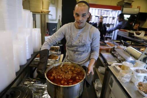 A religious Jewish cook holds a pot of hamin at the Maadaniat Chef restaurant in Bnei Brak. The stew is enjoying a renaissance in Israel
