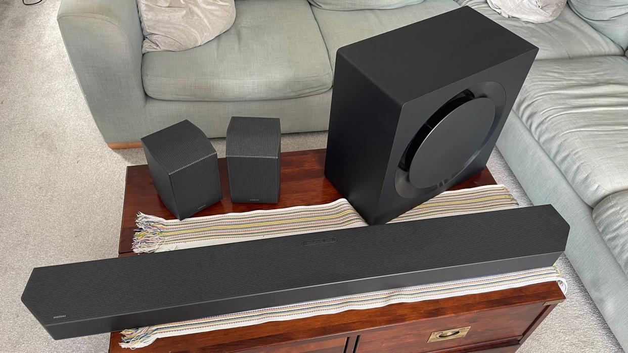  The Samsung HW-Q990C soundbar system pictured on a wooden table. 